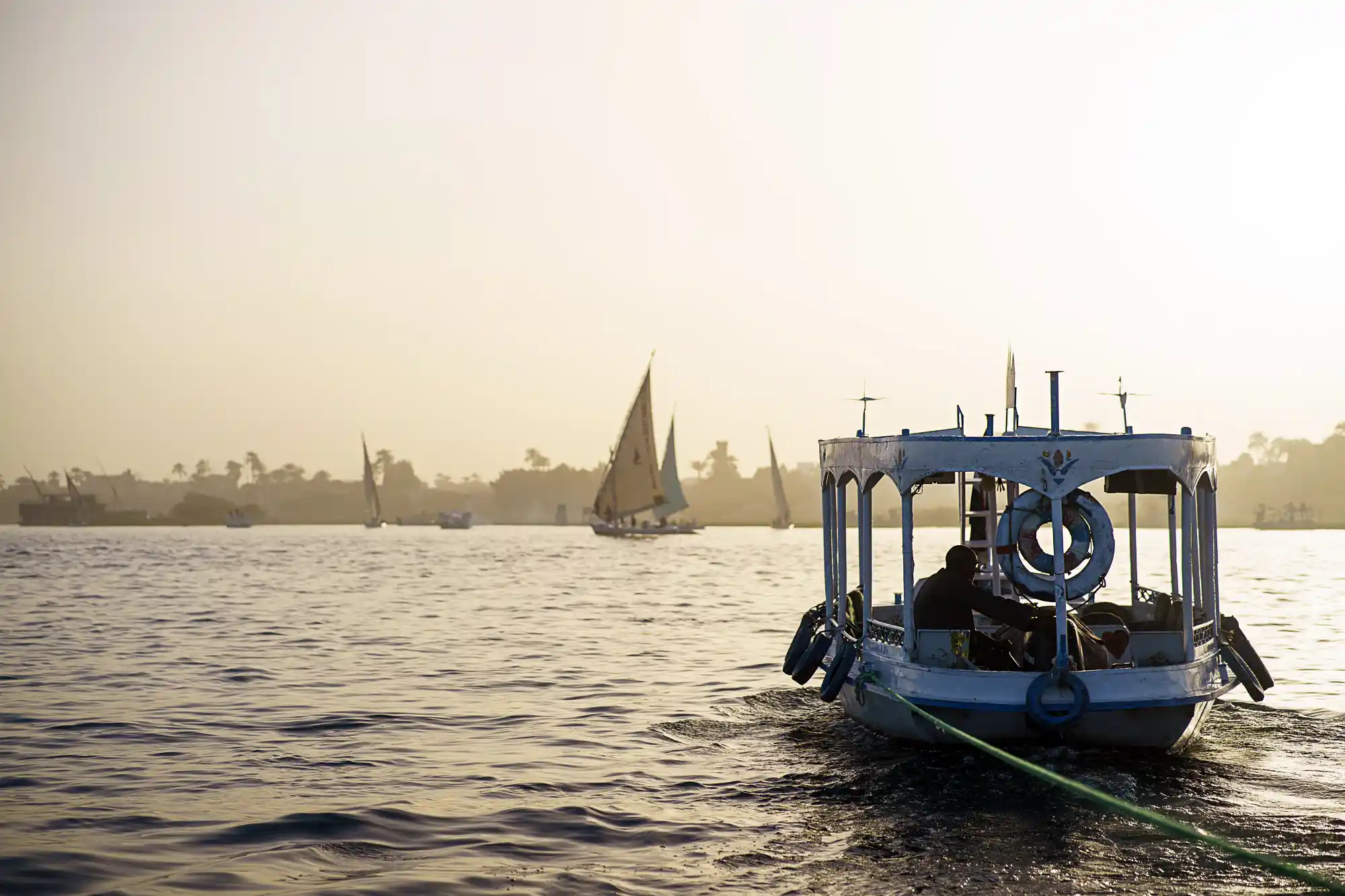 motorboat pulling a felucca