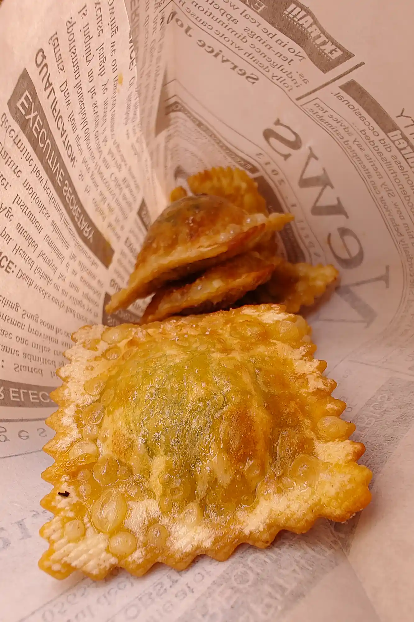 Deep fried ravioli in a newspaper bag