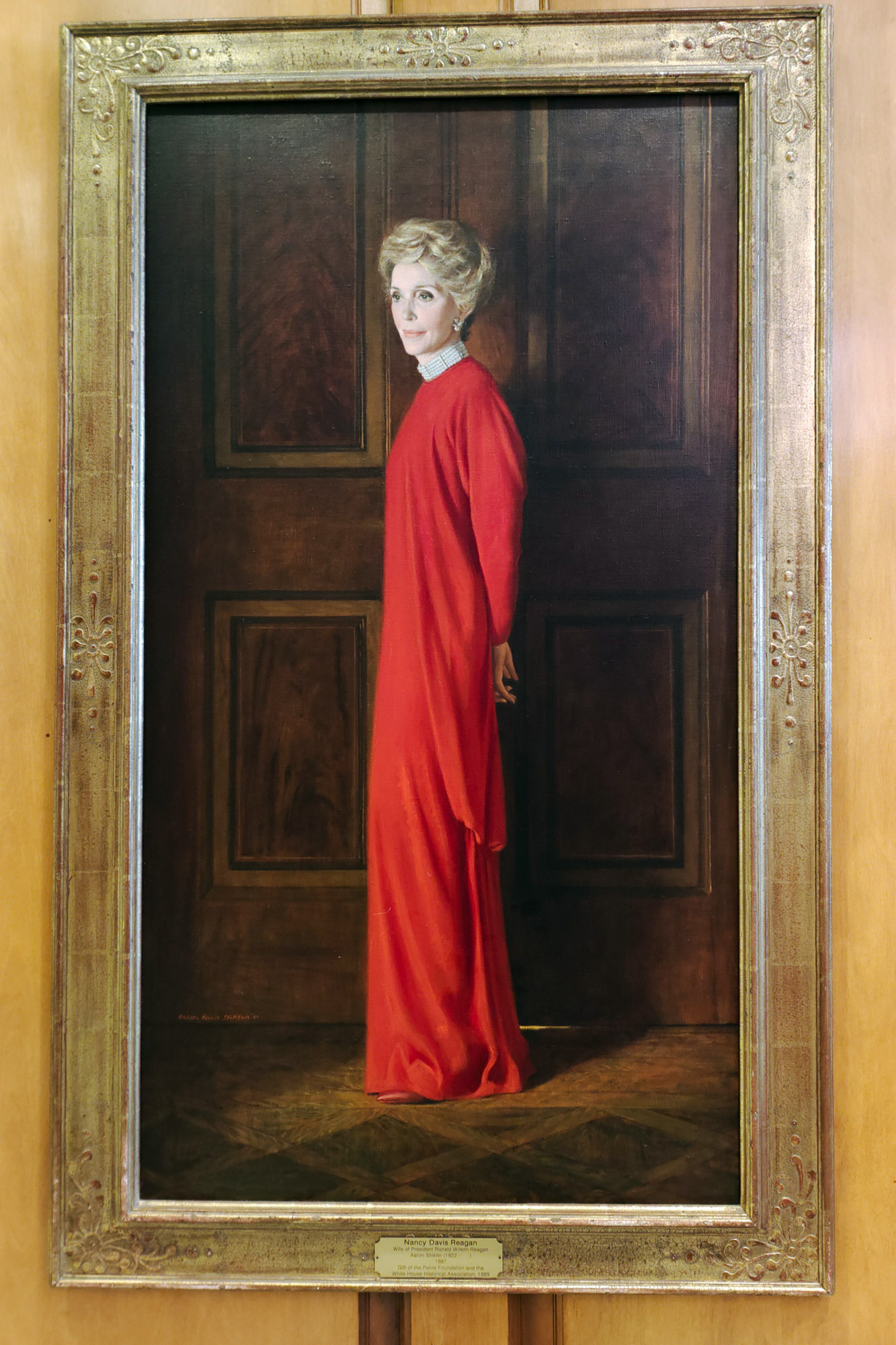 Portrait of Nancy Reagan in a red dress at the White House