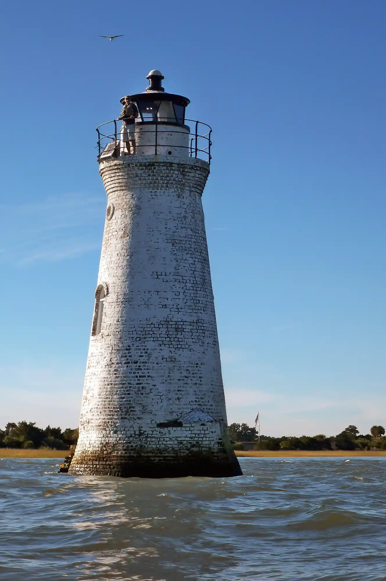 Man standing on small Tybee Island lighthouse