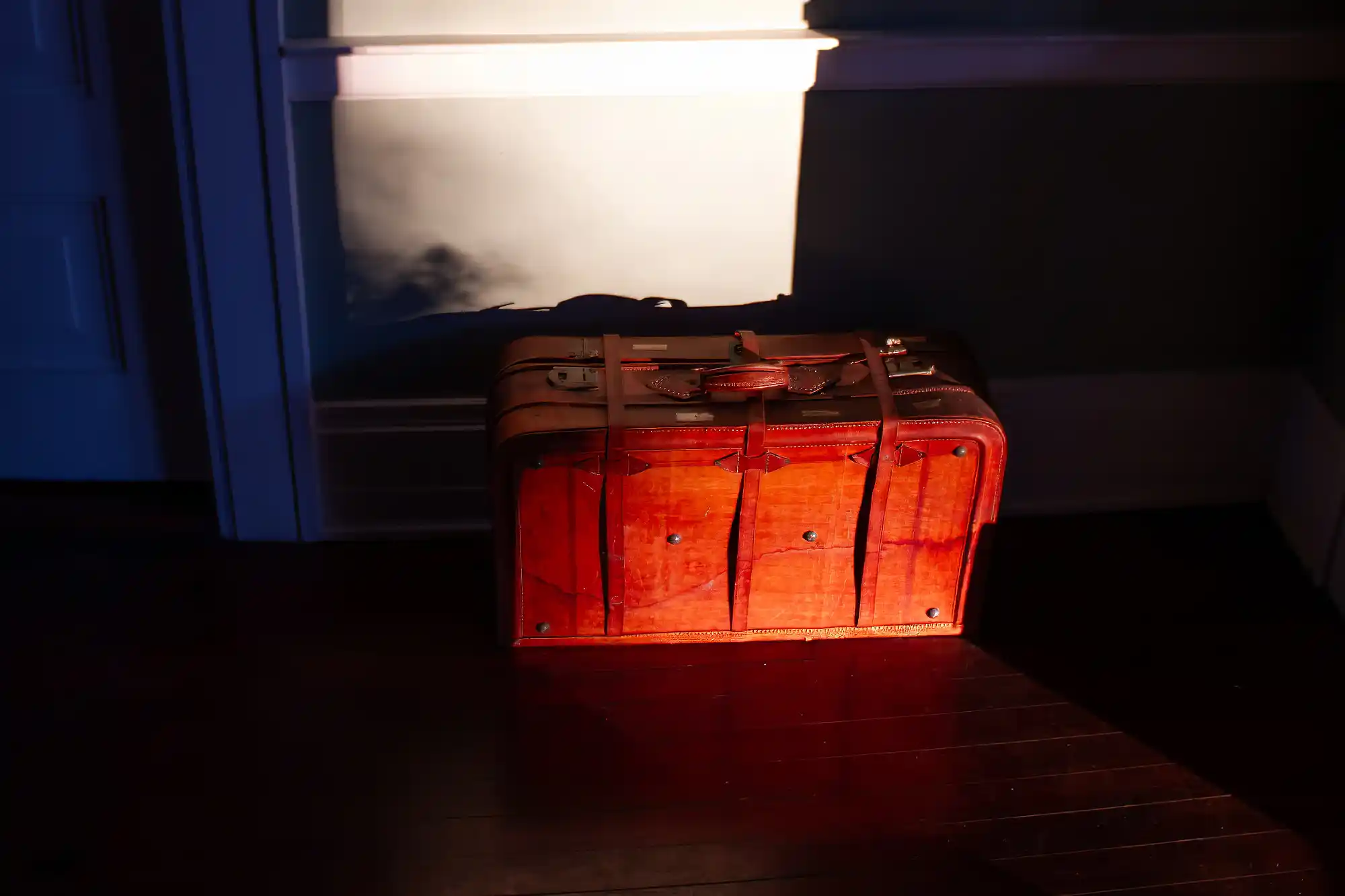 Old leather suitcase sitting in the sun